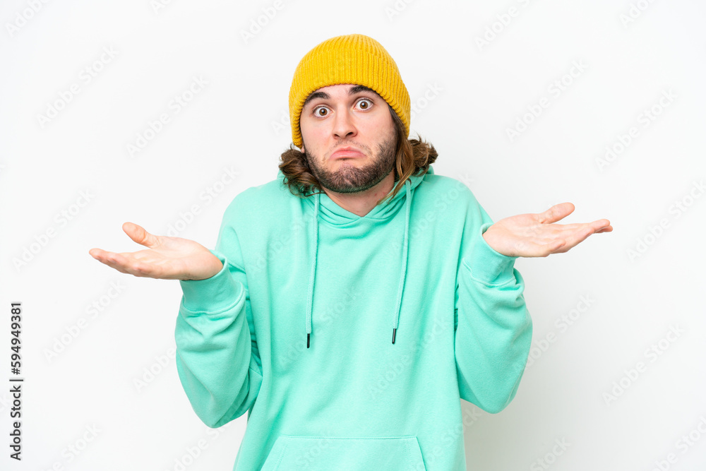 Young handsome man isolated on white chroma background having doubts while raising hands Young handsome man isolated on white chroma background having doubts while raising hands