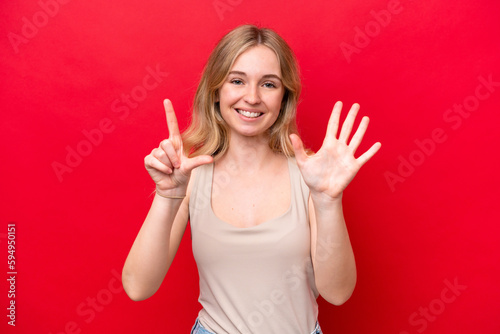 Young English woman isolated on red background counting seven with fingers