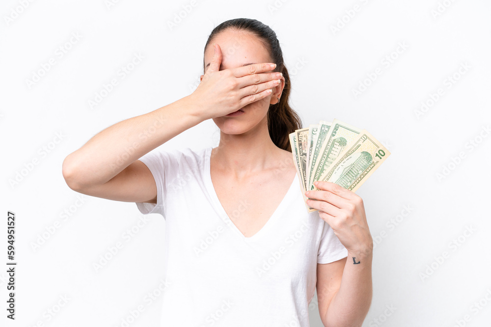 Young caucasian woman taking a lot of money isolated on white background covering eyes by hands. Do not want to see something Young caucasian woman taking a lot of money isolated on white background covering eyes by hands. Do not want to see something