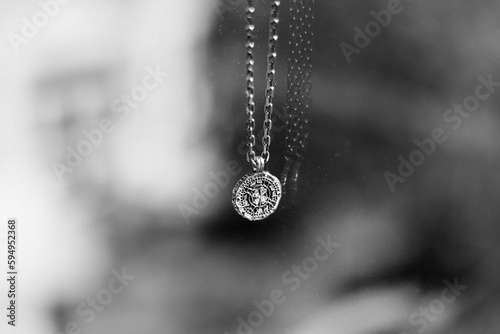 Closeup grayscale shot of a necklace on a blurred background
