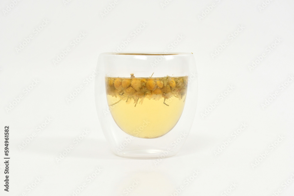 Chamomile tea at double wall glass white chamomile buds. herbal tea. Chamomile tea at double wall glass white chamomile buds. herbal tea.