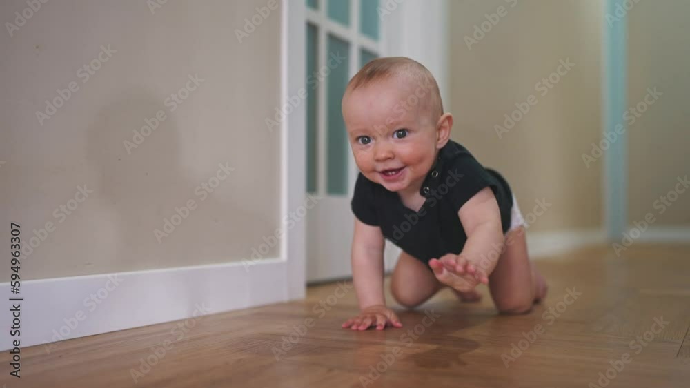 baby son crawling. happy family a first steps kid dream concept. baby newborn crawling down the hallway in the house. happy baby boy crawling on lifestyle the floor takes her first steps baby son crawling. happy family a first steps kid dream concept. baby newborn crawling down the hallway in the house. happy baby boy crawling on lifestyle the floor takes her first steps