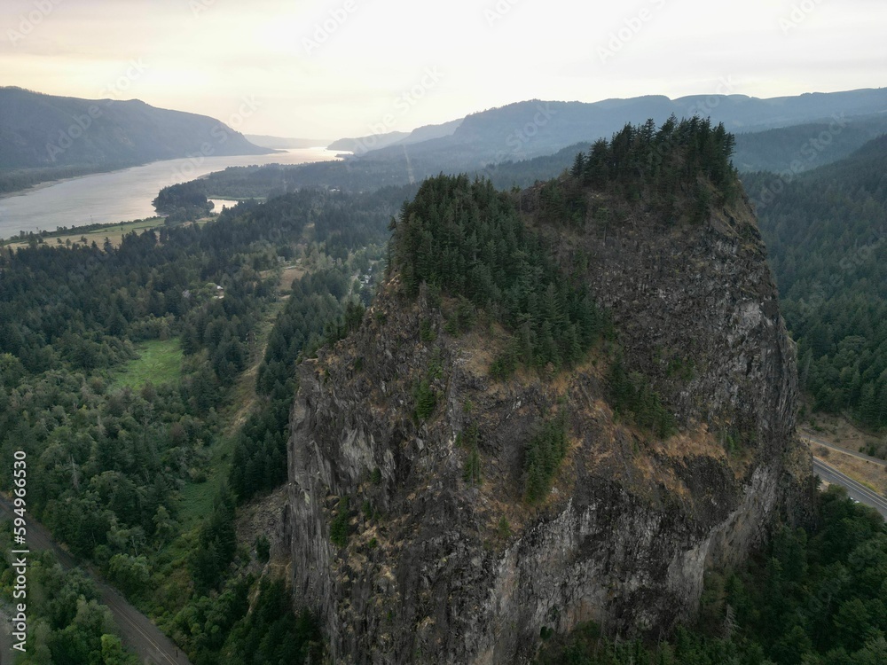 An aerial shot of a mountain near a river An aerial shot of a mountain near a river