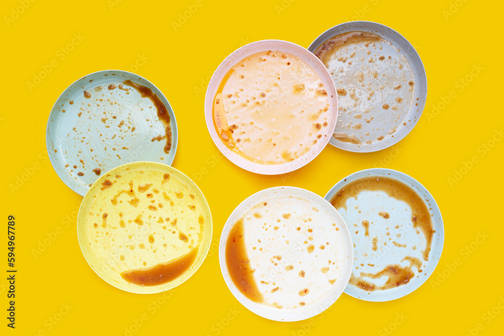 Dirty dishes on yellow background. Top view