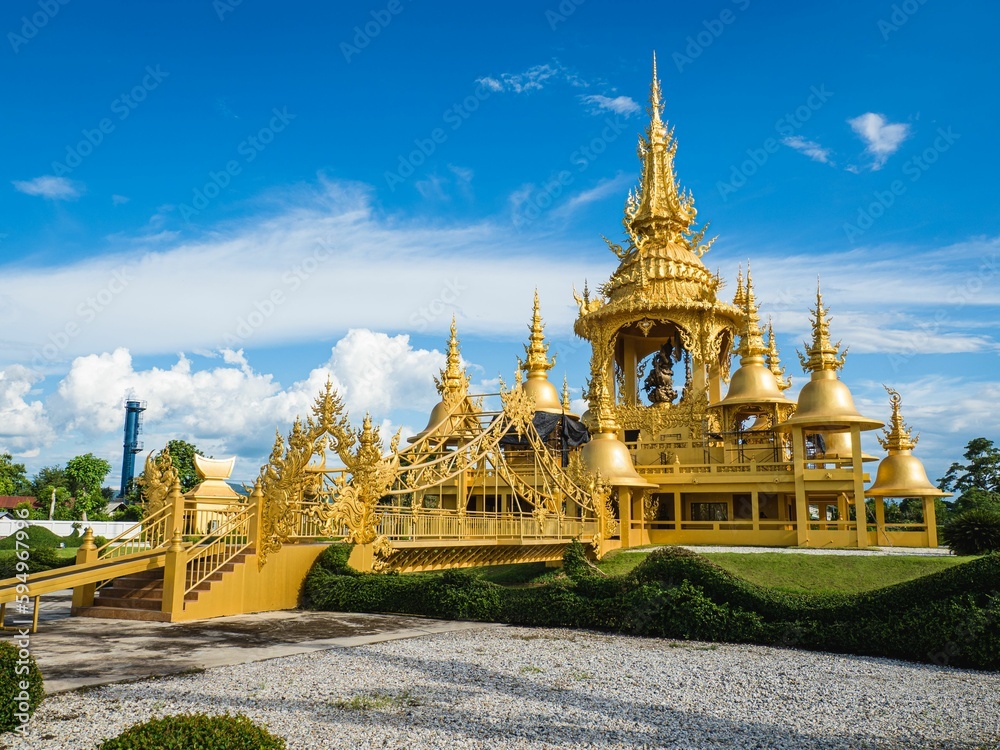 Beautiful Wat Rong Khun White Temple with golden buildings in Chiang Rai, Thailand