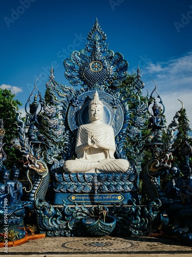 White Buddha idol statue at Chiang Rai's Wat Rong Suea Ten (Blue Temple)