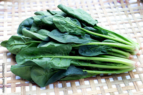 Fresh spinach on bamboo weave plate