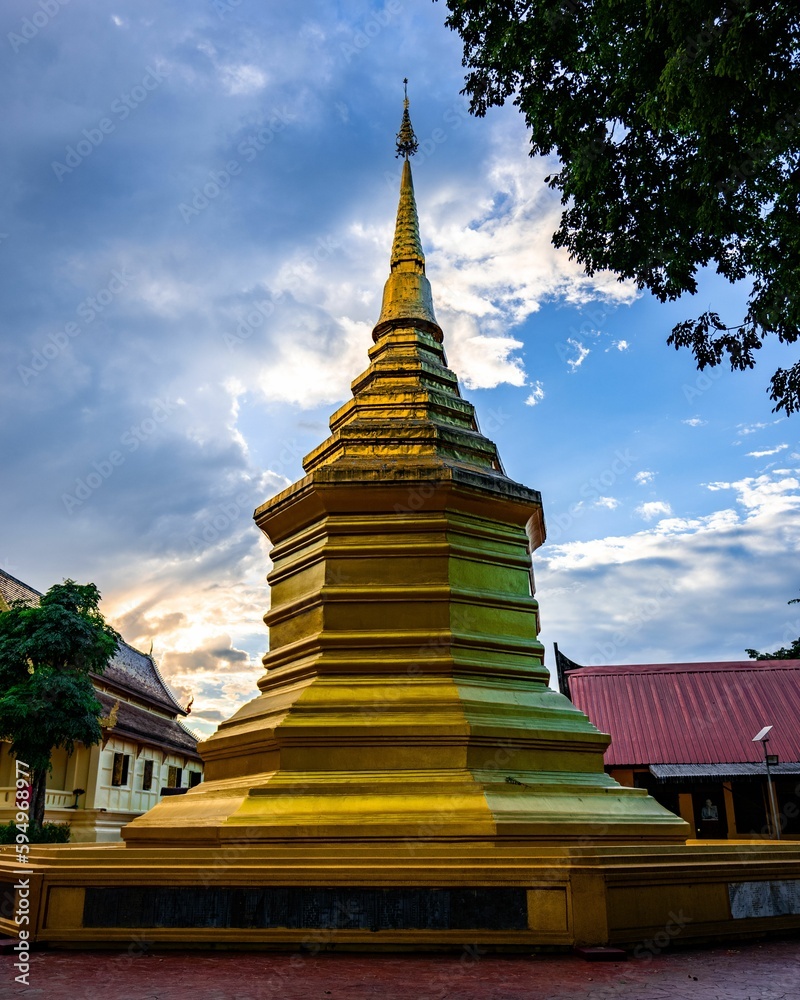 Fototapeta premium Majestic golden pagoda standing in The Navel City Pillar against a backdrop of the sky
