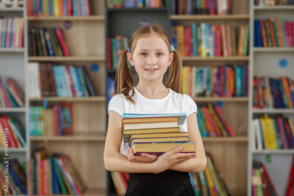 Child buys books in bookstore for learning or reading. Girl choosing book in school library. Child buys books in bookstore for learning or reading. Girl choosing book in school library.