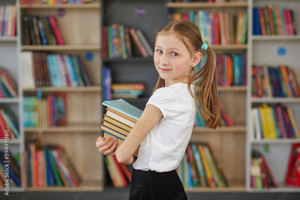 Child buys books in bookstore for learning or reading. Girl choosing book in school library. Child buys books in bookstore for learning or reading. Girl choosing book in school library.