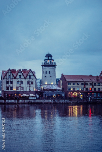 old houses and a lighthouse on the embankment