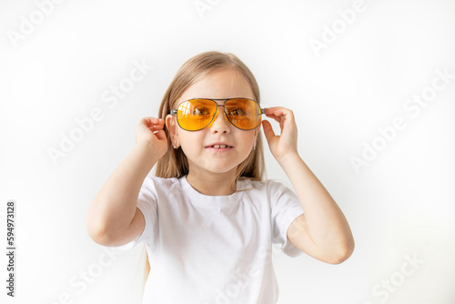Portrait of a child girl in yellow glasses  white background