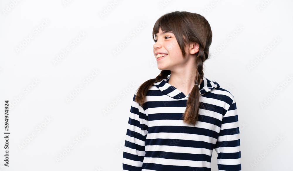 Little caucasian girl isolated on white background looking to the side and smiling Little caucasian girl isolated on white background looking to the side and smiling