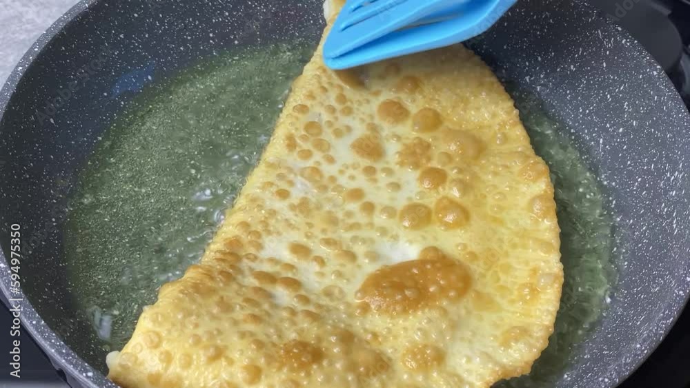 Pasties cheburek with meat fried in sunflower oil, deep fry. Crimean