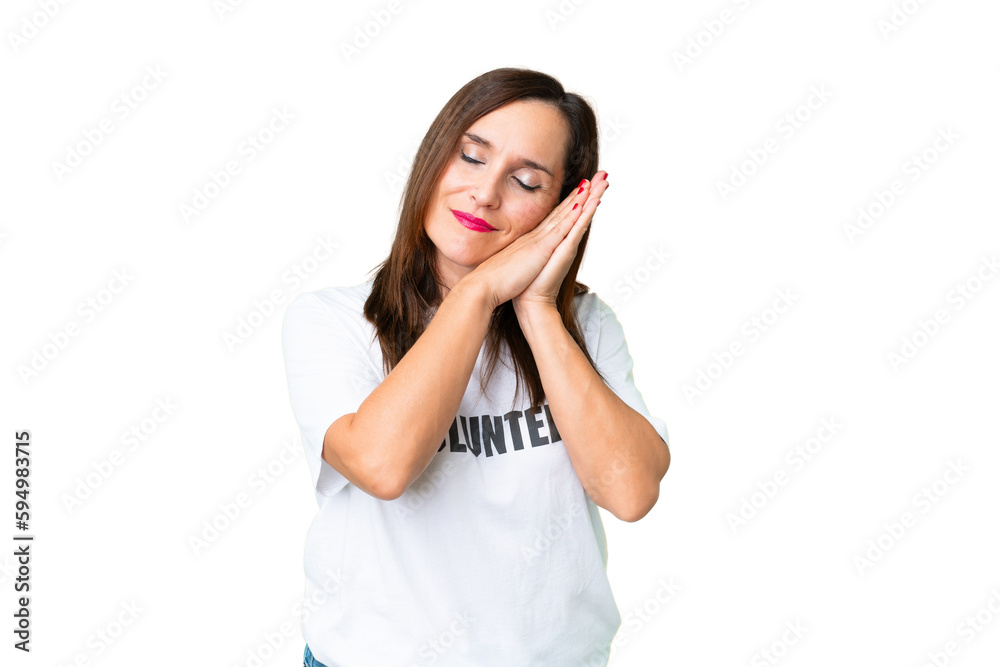 Middle age volunteer woman over isolated chroma key background making sleep gesture in dorable expression Middle age volunteer woman over isolated chroma key background making sleep gesture in dorable expression