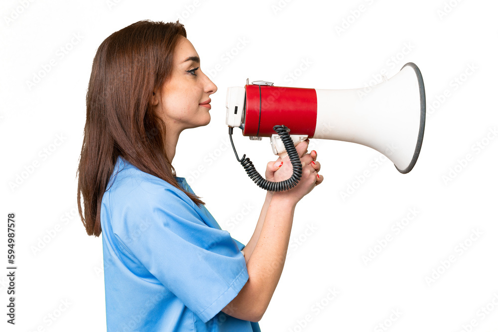 Young nurse woman over isolated chroma key background shouting through a megaphone Young nurse woman over isolated chroma key background shouting through a megaphone