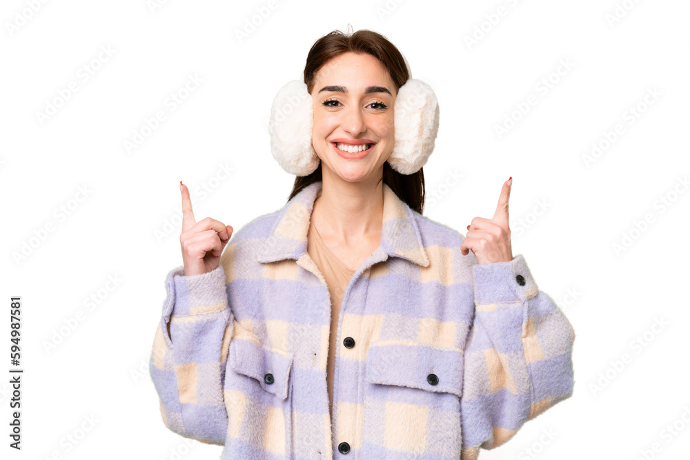 Young caucasian woman wearing winter muffs over isolated chroma key background pointing up a great idea Young caucasian woman wearing winter muffs over isolated chroma key background pointing up a great idea