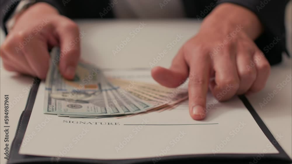 Latino Slides Over Contract with Stack of Cash, Then Points at Signature Line. Shot with ARRI Alexa in ARRIRAW at 23.98 fps and exported QuickTime Apple ProRes 422 HQ. Latino Slides Over Contract with Stack of Cash, Then Points at Signature Line. Shot with ARRI Alexa in ARRIRAW at 23.98 fps and exported QuickTime Apple ProRes 422 HQ.