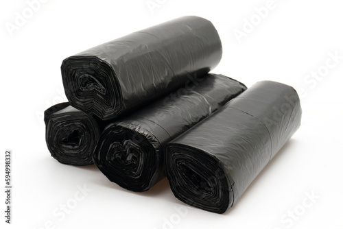 Stack of Unused Black Plastic Trash Bags (Rolls) with Handles on Plain White Background
