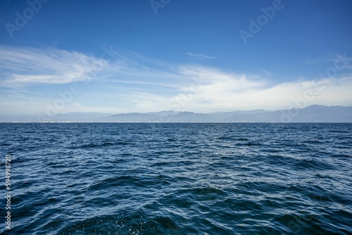 Breathtaking landscape featuring blue ocean with the cloudy blue sky in background in Mexico