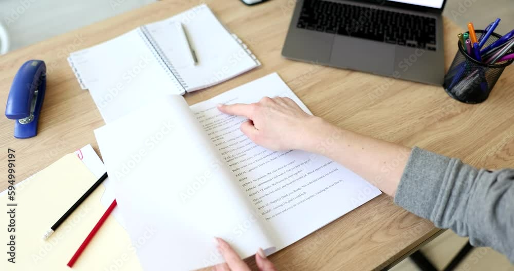 A woman in the office reads a script on paper, a close-up. Sales funnel, lead conversion, slowmotion