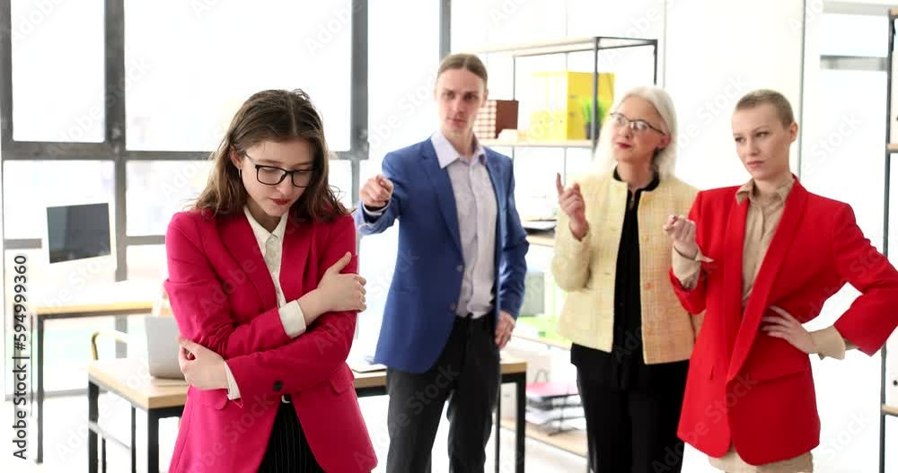 Employees in the office are ashamed of a colleague, a close-up. Psychological pressure at the workplace, mobbing