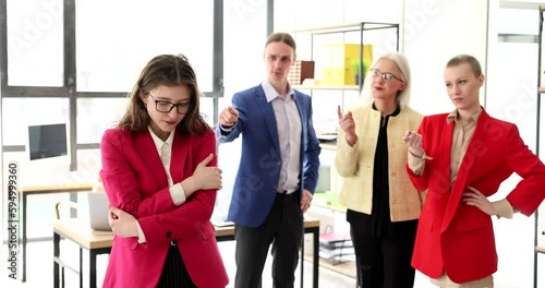 Employees in the office are ashamed of a colleague, a close-up. Psychological pressure at the workplace, mobbing