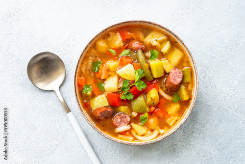 Minestrone soup, italian vegetable soup with smoked sausages, Top view.