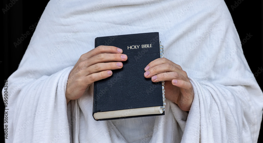 person holding a holy bible book