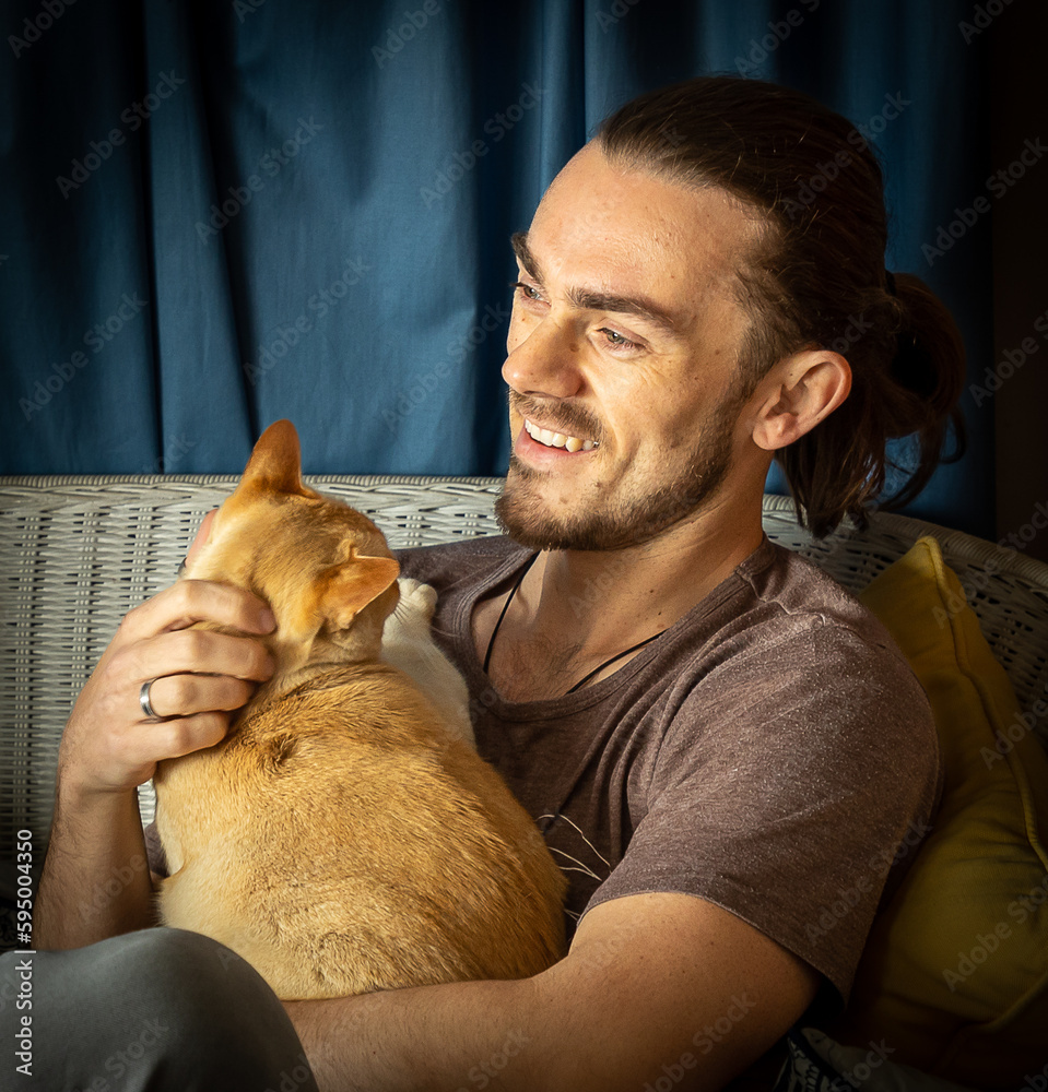 Handsome man holding a cat
