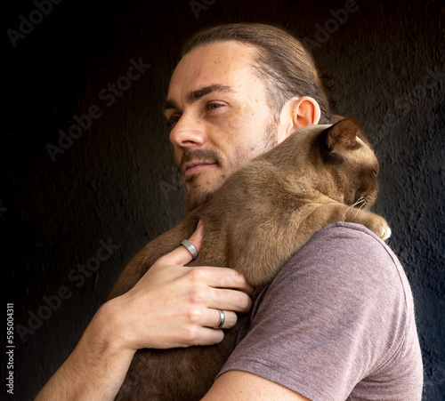 portrait of a person with a Burmese cat