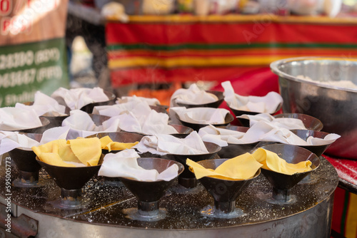 Putu Piring selling during Ramadan bazaar, it is a round-shaped steamed rice flour kueh or sweet snack filled with palm sugar.