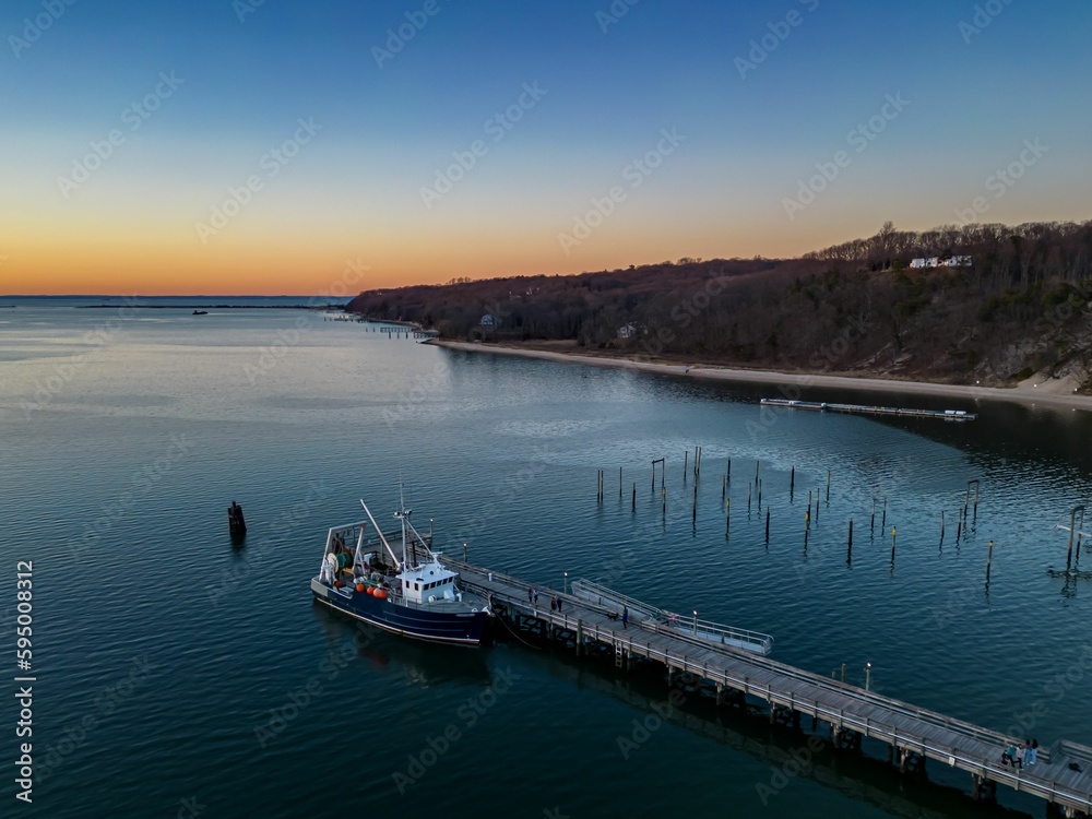 Aerial view of the Port Jefferson Harbor during a beautiful and cloudless sunset in the winter