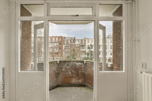 an empty room with brick walls and white doors  looking out onto the street from one end to another area