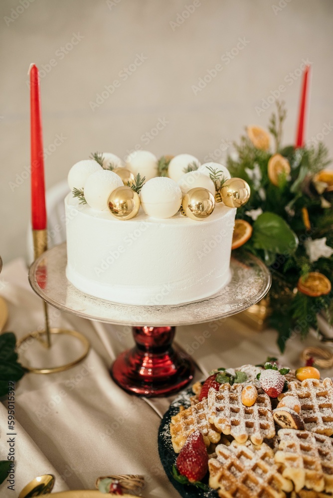 Festive holiday scene featuring a decorated cake on a platter in a Christmas-decorated setting