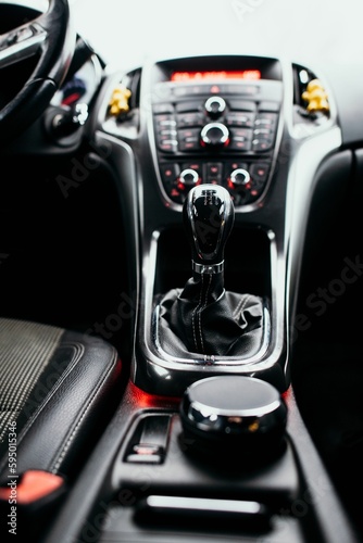 Interior shot of a vehicle, featuring the gear shift knob in a stationary position