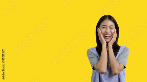 Asian woman smiling happily isolated on yellow background, Woman loves and rejoices herself, Contented, Pure love, Love myself, Proud of yourself, Self-made happiness, Painting Therapy with a smile.