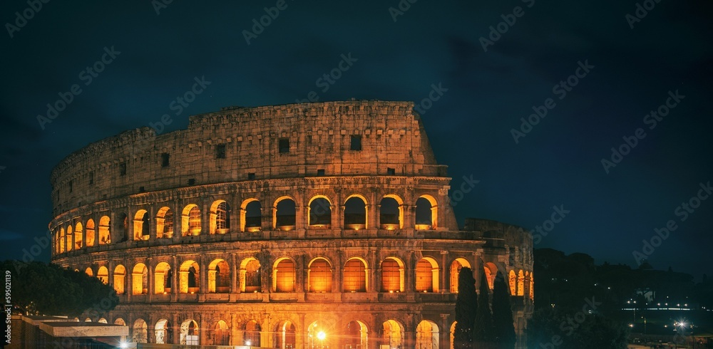Colosseum illuminated with lights in the evening in Rome, Italy