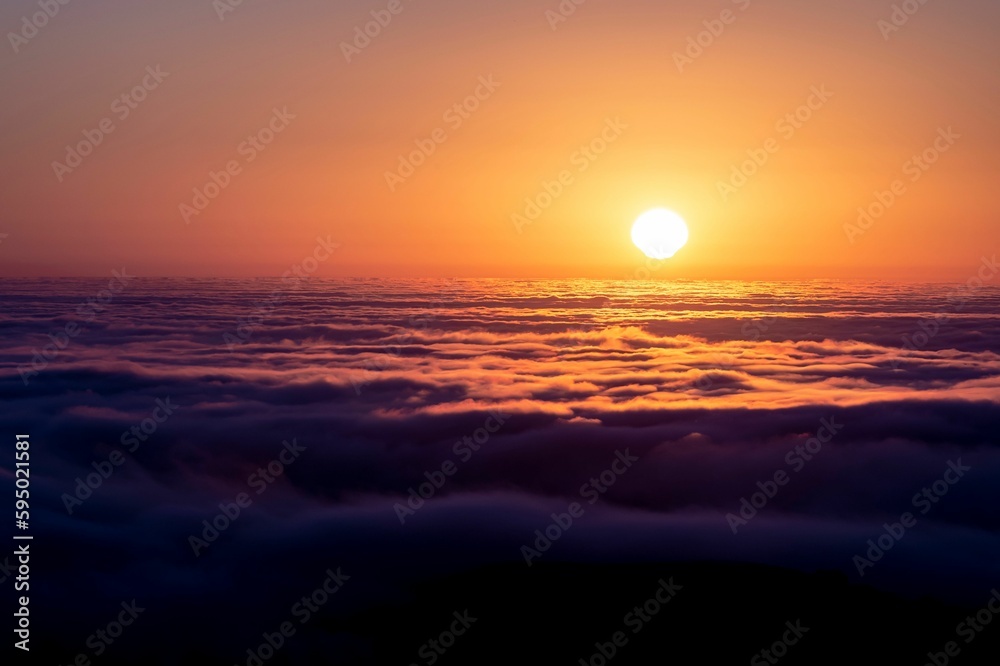 View of a serene evening sky featuring a beautiful sunset of pastel hues over the clouds