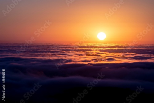 View of a serene evening sky featuring a beautiful sunset of pastel hues over the clouds © Crown Moto/Wirestock Creators
