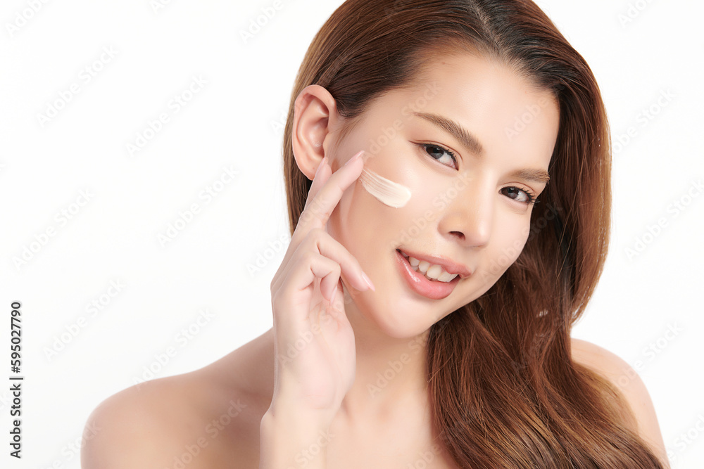 Beautiful young asian woman smiling and applying face cream on white background, Skin care and rejuvenation, Face care, Facial treatment, Cosmetology, beauty,