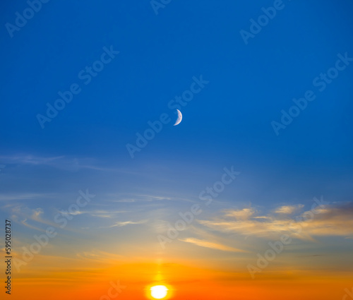 evening sun and halh moon on cloudy sky, dramatic sunset background photo