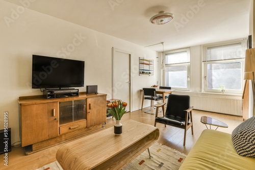 a living room with a flat screen tv on the wall and an entertainment unit in the corner of the room