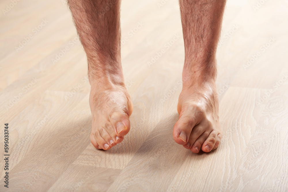 man doing flatfoot correction gymnastic exercise at home man doing flatfoot correction gymnastic exercise at home