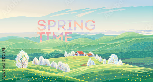 Spring rural landscape with hills and flowering fruit trees and also with a village in the background.