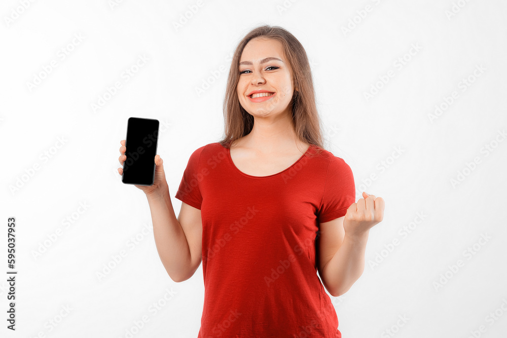 Online Win. Portrait of overjoyed brunette girl making winner gesture and showing blank mobile phone screen, standing over white background Online Win. Portrait of overjoyed brunette girl making winner gesture and showing blank mobile phone screen, standing over white background