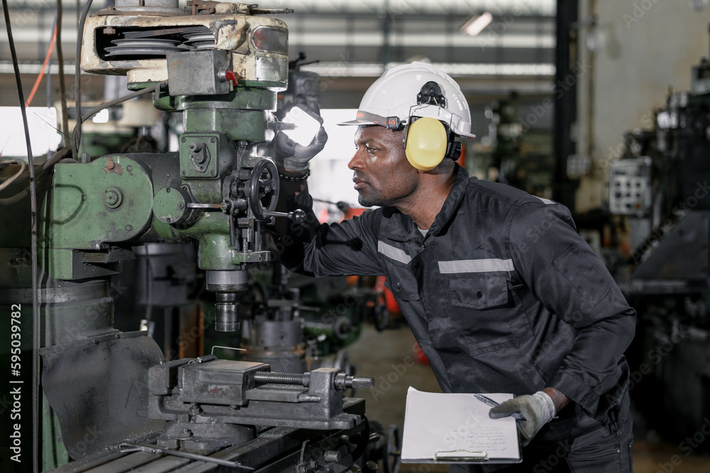 Skilled robotic technician spots the light on robotic components to do protective and corrective maintenance. Inspecting complex mechanical systems. Repairing and troubleshooting to resolve issues. Skilled robotic technician spots the light on robotic components to do protective and corrective maintenance. Inspecting complex mechanical systems. Repairing and troubleshooting to resolve issues.