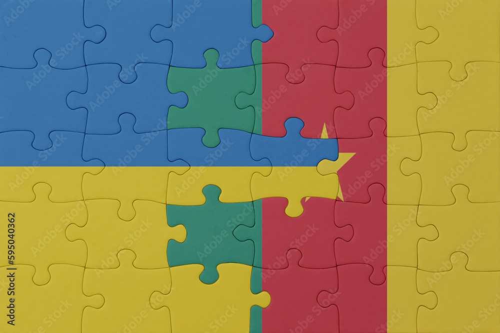 puzzle with the national flag of ukraine and cameroon . macro.concept. puzzle with the national flag of ukraine and cameroon . macro.concept.