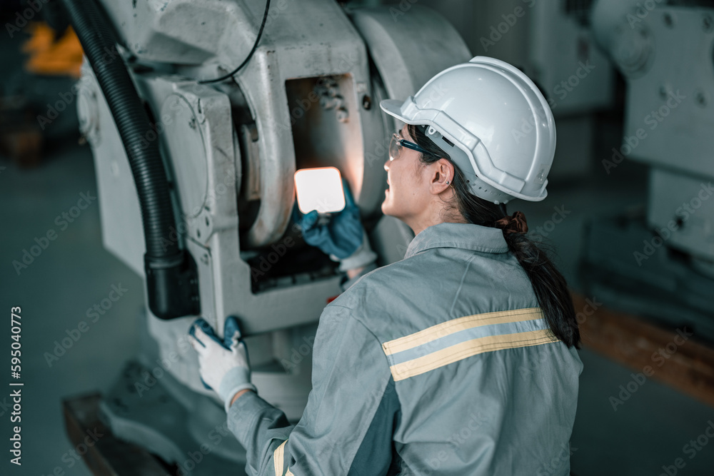 Skilled robotic technician spots the light on robotic components to do protective and corrective maintenance. Inspecting complex mechanical systems. Repairing and troubleshooting to resolve issues. Skilled robotic technician spots the light on robotic components to do protective and corrective maintenance. Inspecting complex mechanical systems. Repairing and troubleshooting to resolve issues.