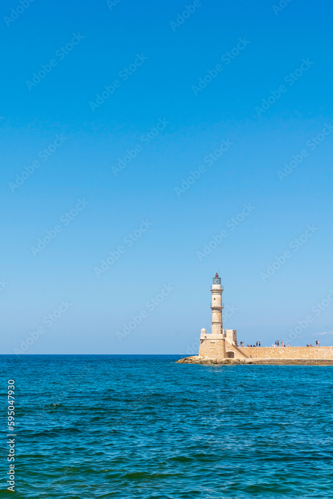 Lighthouse in mediterranean sea. Holidays in Greece